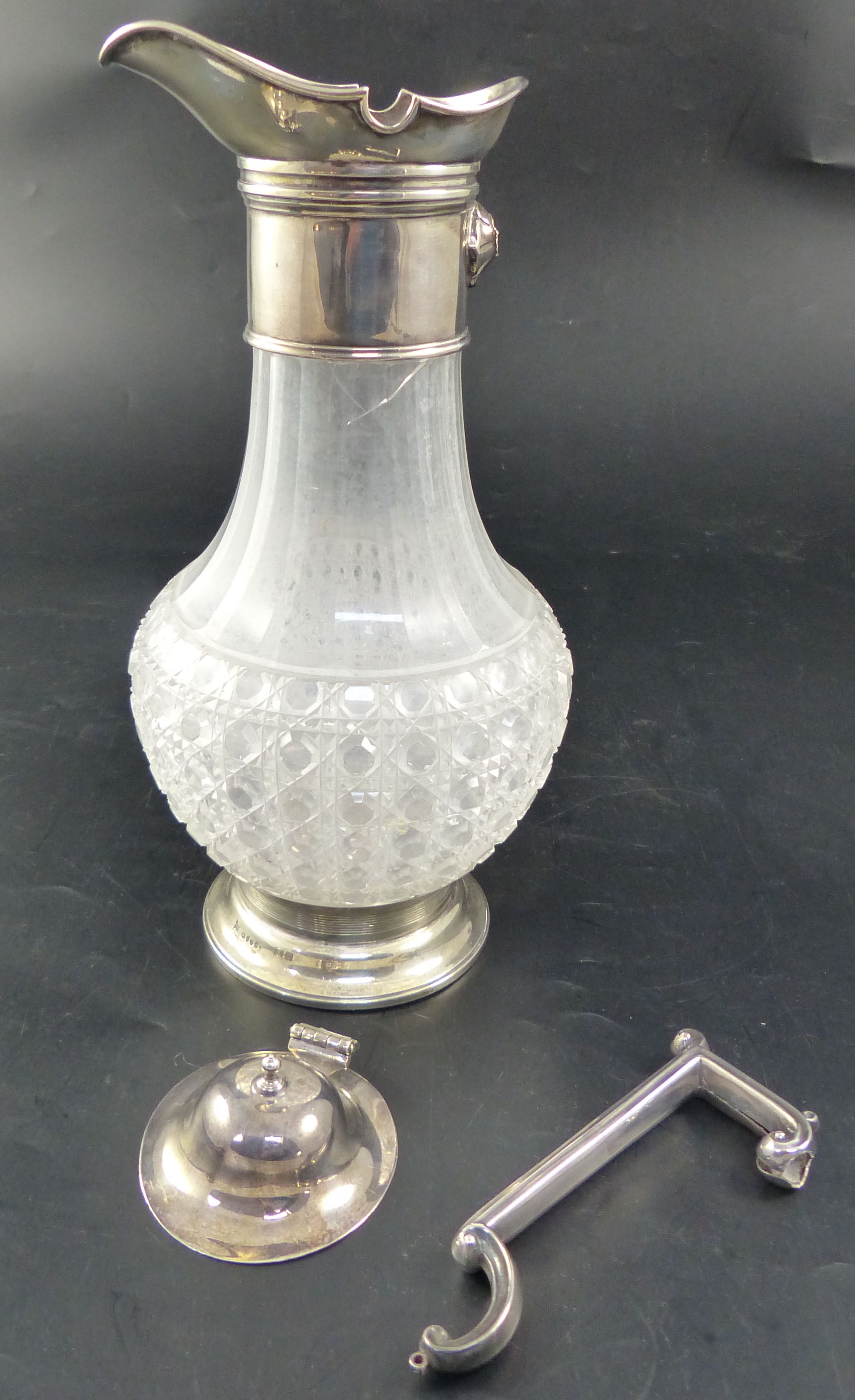 A Victorian silver mounted cut-glass claret jug, height 27.9cm (handle and lid detached/broken)